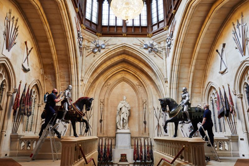Members of staff at Windsor Castle dust the suits of armour that flank the Grand Staircase 